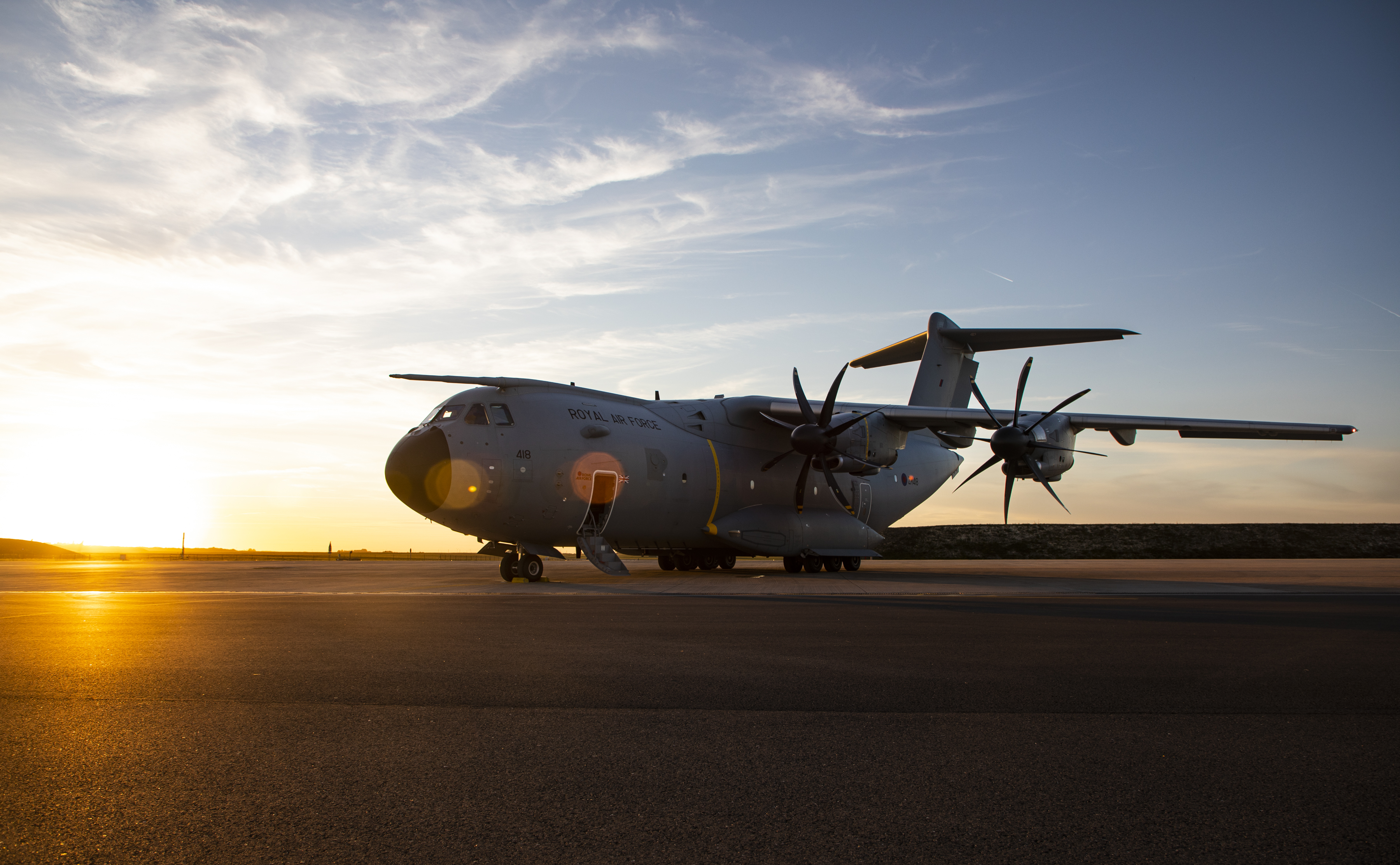 Image shows a RAF Atlas on the airfield with sunset.